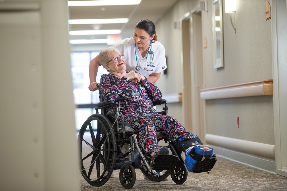 nurse assisting woman in wheelchair
